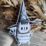 Sticker featuring a tiny wizard spirit in a big hat, from my original pen and ink artwork.

Die-cut vinyl sticker, suitable for interior or exterior use. Available as a single sticker or a set of five matching stickers to share with friends. Measures approximately 8.5cm (3.3 inches) at its tallest point.&nbsp;