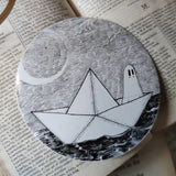 A little ghostie on the high seas, printed on a sticker to add some spooky charm to your laptop, water bottle, or any other surface. From my original pen and ink artwork.

Die-cut vinyl sticker, suitable for interior or exterior use. Measures approximately 76mm (3 inches) across.