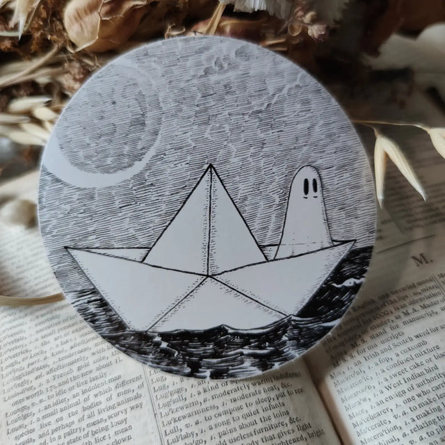 A little ghostie on the high seas, printed on a sticker to add some spooky charm to your laptop, water bottle, or any other surface. From my original pen and ink artwork.

Die-cut vinyl sticker, suitable for interior or exterior use. Measures approximately 76mm (3 inches) across.