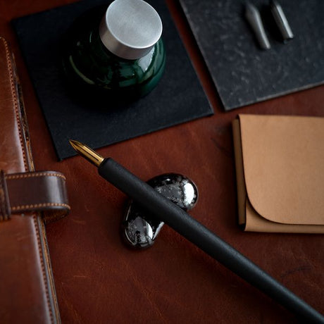 Our Hasami ware pen rests are inspired by the natural form of droplets. Four distinctive colours have been specially selected from an extensive variety of glazes. The soft contours gently guide and hold your pen in place.

Four colours were chosen to celebrate the unique richness of Hasami porcelain and glazes.

The golden glaze has an unassuming presence when raw. The unique and variable nature of pottery work is evident here with the finished colouring dictated by the position inside the kiln and revealed