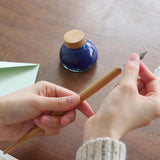 Experience the feel of natural wood. Japanese cherry is known for its reddish colour that deepens over time, allowing you to enjoy your pen’s unique transformation. An ink-resistant finish ensures practicality while maintaining the natural appeal of wood.

A nib holder crafted from Japanese cherry. Designed for ease of writing, the 7-inch length fits comfortably in the hand like a standard pencil. Partner with your favourite nib, or switch nibs to suit your mood. Fits most nibs as well as those from our ran