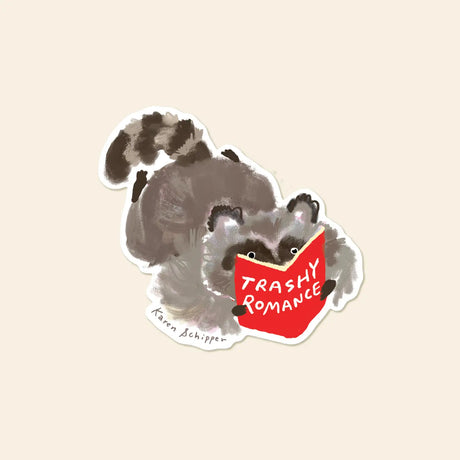 Karen Schipper Vinyl Sticker - Trashy Romance Racoon

Trashy Romance Racoon features a fluffy raccoon sprawled out with a bright red paperback titled TRASHY ROMANCE — a funny sticker that feels cozy, cheeky, and instantly giftable.

Made from matte-coated, waterproof vinyl, it’s durable enough for laptops, planners, water bottles, and more. It’s an easy impulse add-on for cat people, best friends, and shoppers looking for a small but meaningful gift.

Measures approximately 3 inches
Matte coating; durable, 