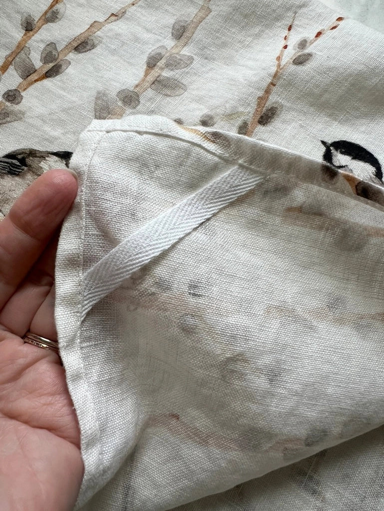 Introducing a gorgeous watercolor pattern of black capped chickadees and fuzzy spring willows that will add a touch of elegance and serenity to your home. Bringing a sweet whisper of the outdoors into your kitchen.

Crafted from 100% premium linen, this towel measures 17.5 x 26 inches, blending beauty with utility. Each comes with a belly band, perfect for gifting and a corner hang loop for hanging.

Designed by Kasey. Imported.

Artwork copyright Kasey Melissa Art 2024.