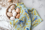 Introducing this bright spring colored pattern of blue birds and yellow forsythia that will add a touch of elegance and serenity to your home. Bringing a sweet whisper of the outdoors into your kitchen.

Crafted from 100% premium linen, this towel measures 17.5 x 26 inches, blending beauty with utility. Each comes with a belly band, perfect for gifting and a corner hang loop for hanging.

Designed by Kasey. Imported.

Artwork copyright Kasey Melissa Art 2025.