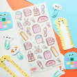 @catsoul_draws has put together the sweetest set of supplies, where even the stationery comes with whiskers and toe beans! From paw-print box cutters and cat-shaped rulers to notebooks, scissors, calculators, and washi tape, these kawaii supplies are here to make any workday a little more pawsitive.

Art by: @catsoul_draws


One sticker sheet is included.
Top Coating: None
Adhesive Layer: Paper
Backing Layer: Clear PET 
Size: 6.69"x3.54"
Weight-0.03oz