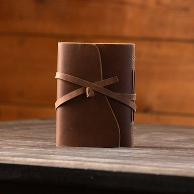 Kodiak Leather Traveler's Journal - Medium

The Kodiak Traveler Journal is the perfect travel companion. Made with durable top grain leather, a leather wrap closure and handmade artisan paper this journal is the ultimate gift item for the world traveler or home-body.

• 110 blank pages
• Made with handmade artisan paper
• Top Grain Leather
• Dimensions: 5" x 7"