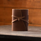 Kodiak Leather Traveler's Journal - Medium

The Kodiak Traveler Journal is the perfect travel companion. Made with durable top grain leather, a leather wrap closure and handmade artisan paper this journal is the ultimate gift item for the world traveler or home-body.

• 110 blank pages
• Made with handmade artisan paper
• Top Grain Leather
• Dimensions: 5" x 7"