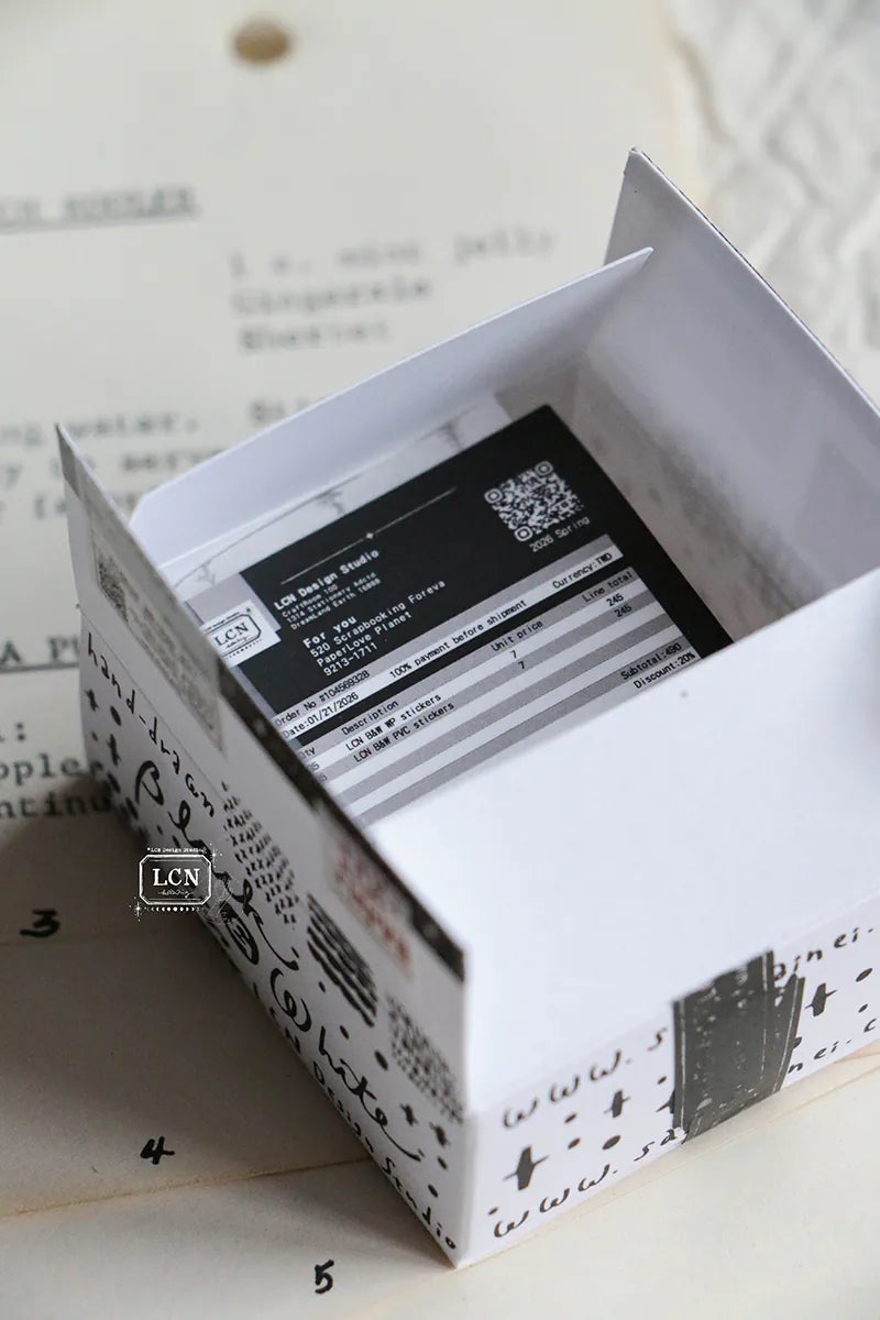 A mini package box full of black and white stickers!
How cute is that!
It has everything: a fragile sticker, shipping label, and even an invoice!
That invoice is also a sticker!