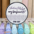 Do you love adding interactive elements to your scrapbook layouts like photos, journaling cards, patterned paper, ephemera, and keepsakes, but want a clean, professional way to attach them without bulky adhesives or visible hinges?

Tip In Tape™ was designed for exactly that.

Tip In Tape™ is a clear matte PET tape created for adding interactive elements to scrapbook pages and paper crafting projects with precision and ease. It allows you to create flip-ups, tip-ins, layered details, and movable elements wh