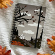 A new A5 notebook featuring ghosties strolling through the cemetery!

This hardcover notebook comes lined and with an elastic band. There are 96 double sided pages.