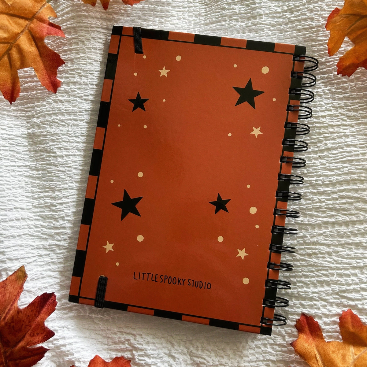 A new A5 notebook featuring a ghost dressing up as a witch!

This hardcover notebook comes lined and with an elastic band. There are 96 double sided pages.