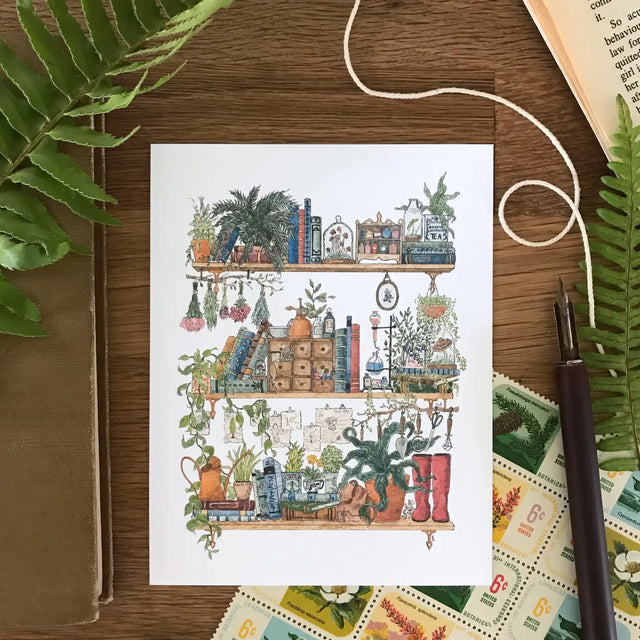 Lizzy Gass Postcard - The Botanist's Shelves

Postcard featuring my original watercolor and ink illustration of the vintage oddities and books tucked away in the shelves of a botanist, including lots of mushrooms, a tiny mouse, and red rain boots for traipsing through forests and fields to collect samples.

• Printed and cut in my studio on high quality, matte card using archival ink

• Each postcard measures 4.25 x 5.5" (A2)