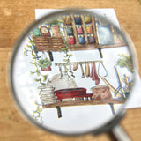 Postcard featuring my original watercolor and ink illustration of the vintage oddities and books tucked away in the shelves of a potter, including glaze test tiles, a tiny kiln, and a bowl of sponges.
