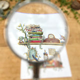 Postcard featuring my original watercolor and ink illustration of the vintage oddities and books tucked away in the shelves of a vintage writer, including a Poe pencil holder, a stained glass lamp, and a blue typewriter.