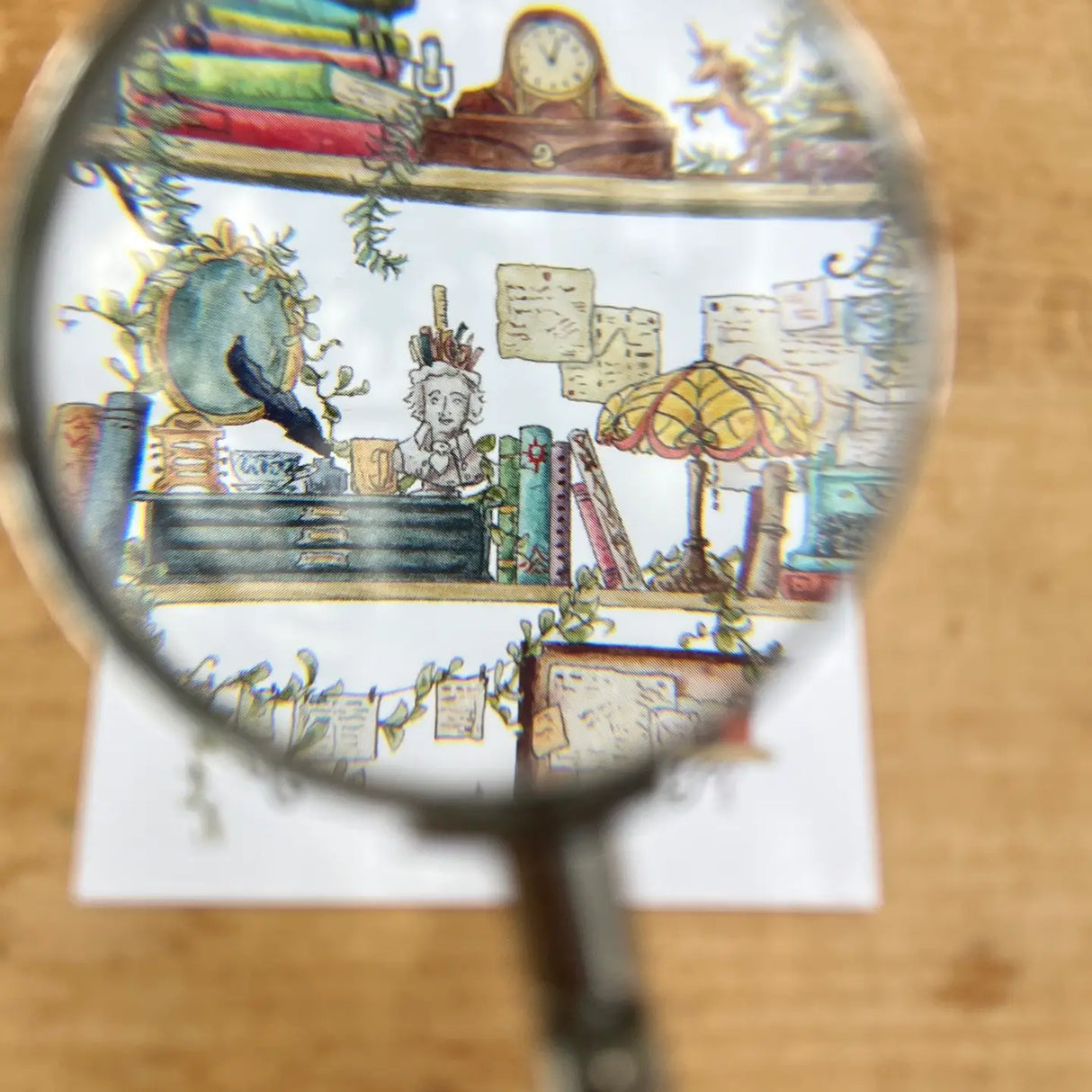 Postcard featuring my original watercolor and ink illustration of the vintage oddities and books tucked away in the shelves of a vintage writer, including a Poe pencil holder, a stained glass lamp, and a blue typewriter.