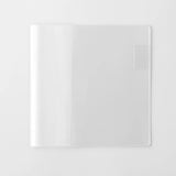 A transparent cover that fits snugly around your MD Notebook

This is a special cover that gently wraps your MD Notebook. The transparent cover protects the notebook from dirt without ruining its appearance.
It subtly protects your notebook from water and dirt without interfering with its characteristics. If you put the cover on with the glassine paper still wrapped around it, the inorganic feel of the vinyl will be softened.
Because it is transparent, you can enjoy the cover design, illustrations, and writ