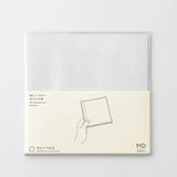 A transparent cover that fits snugly around your MD Notebook

This is a special cover that gently wraps your MD Notebook. The transparent cover protects the notebook from dirt without ruining its appearance.
It subtly protects your notebook from water and dirt without interfering with its characteristics. If you put the cover on with the glassine paper still wrapped around it, the inorganic feel of the vinyl will be softened.
Because it is transparent, you can enjoy the cover design, illustrations, and writ