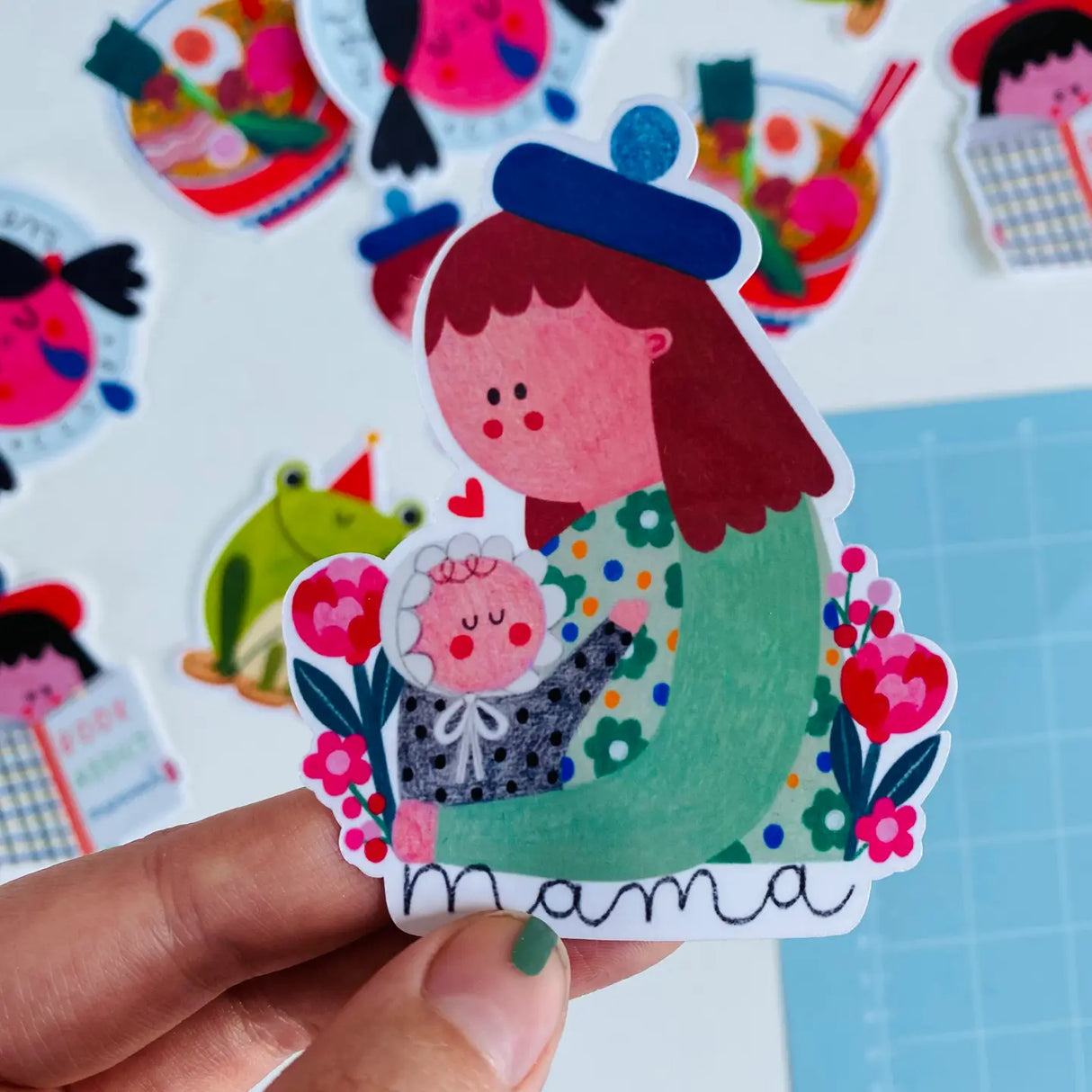 Express your love for motherhood with our MAMA sticker from Daria Solak Illustrations. Sized at a compact 8 cm, it's a perfect add-on to your laptop, notebook, or water bottle. Born from hand-drawn illustrations and locally printed, this sticker embodies the brand's commitment to creating designs that bring joy. Daria Solak, a London-based illustrator, creates colorful designs that make everyone smile. Add a touch of whimsy to your day with this delightful sticker.