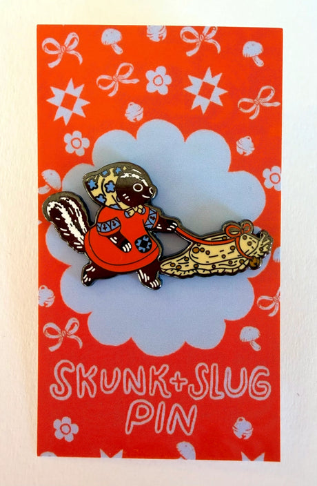 A Skunk and their friend the Slug take a walk through the forest.

This hard enamel pin measures approximately 1.75" and features a rubber clasp for easy closure and two back posts so pin stays where you stick it. Comes with a back card.