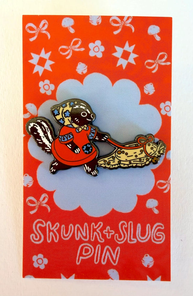 A Skunk and their friend the Slug take a walk through the forest.

This hard enamel pin measures approximately 1.75" and features a rubber clasp for easy closure and two back posts so pin stays where you stick it. Comes with a back card.