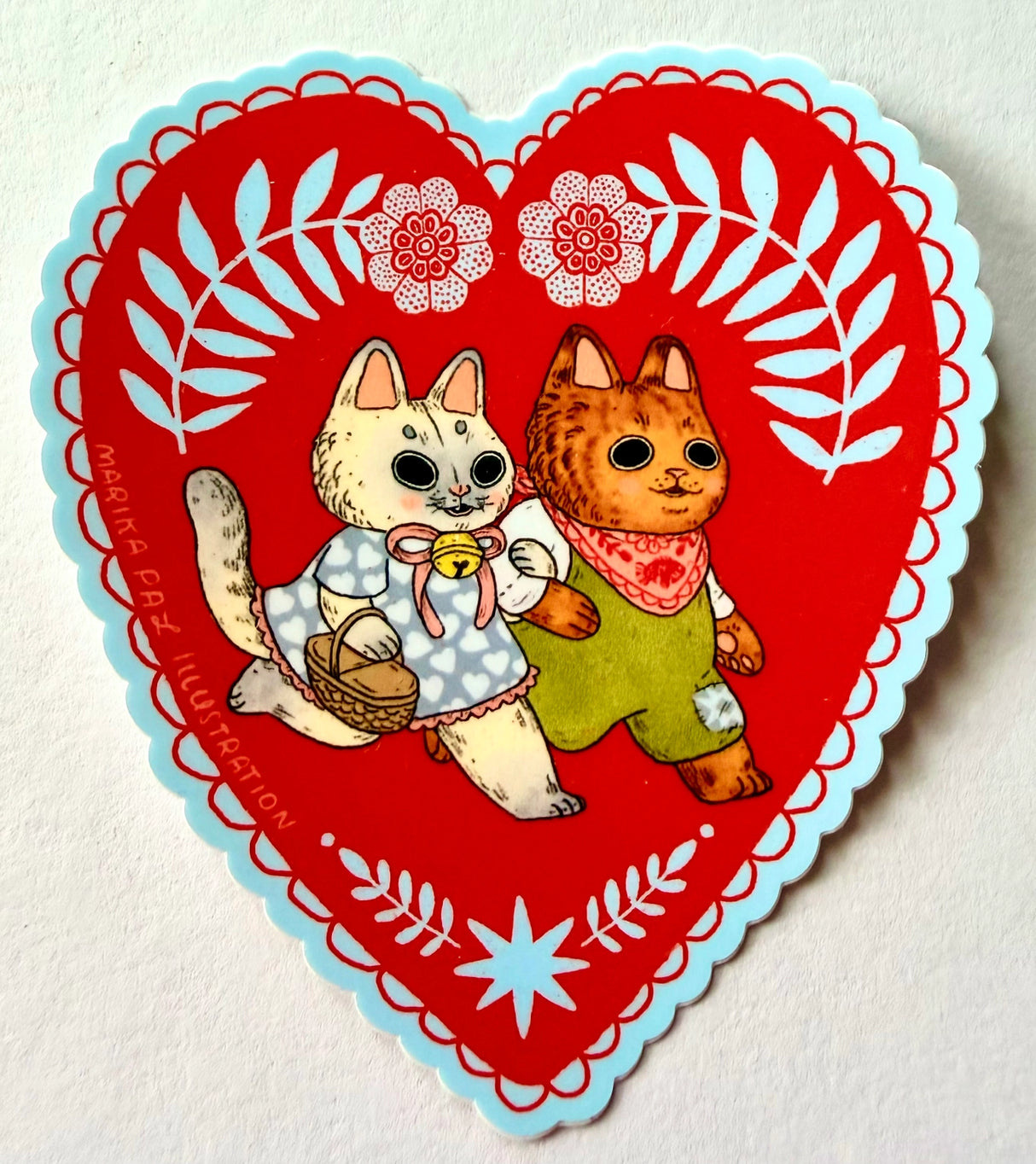 Two cats go for a walk on this folk art inspired sticker.

This vinyl matte sticker is weather and waterproof-stick it on a notebook, bike, or car- it's going to stick around! Heck, throw it on a water bottle and through the dishwasher. This sticker can go anywhere. Sticker measures 3.5" x 4.5" Printed in USA.