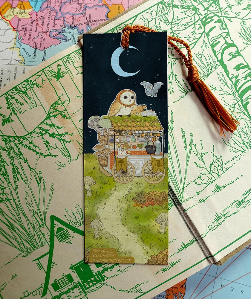 Acorn Market is open for business. Day or night, Owl will be attending its customers.

Bookmarks are double sided with different art of the market open in day and night on each side.

Printed on heavy cardstock and comes with a tassel, these bookmarks measure 2x6 inches.&nbsp;

Printed in USA