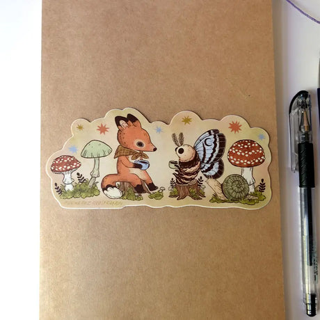 Two friends sit down for tea. This vinyl matte sticker is weather and waterproof-stick it on a notebook, bike, or car- it's going to stick around! Heck, throw it on a water bottle and through the dishwasher. This sticker can go anywhere.

Sticker measures 2.5" x 5.5"

Printed in USA.