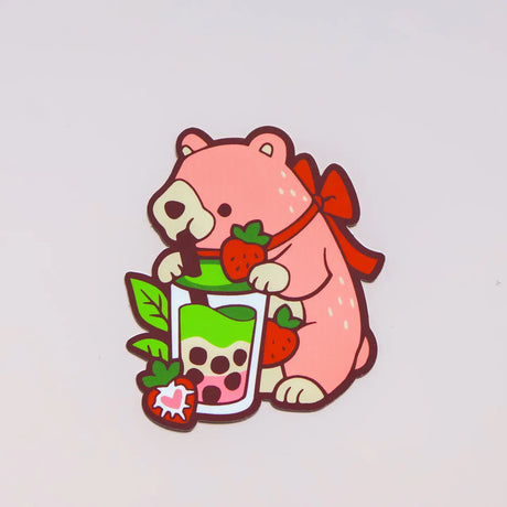 Cartoon bear holding a strawberry and a glass of bubble tea on a light gray background