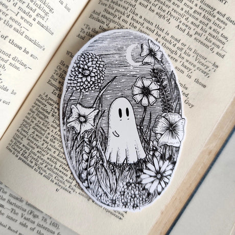 A little ghostie in a flower meadow, printed on a sticker to add some wholesome spooky charm to your laptop, water bottle, or any other surface. From my original pen and ink artwork.

Die-cut vinyl sticker, suitable for interior or exterior use. Measures approximately 76mm (3 inches) tall.