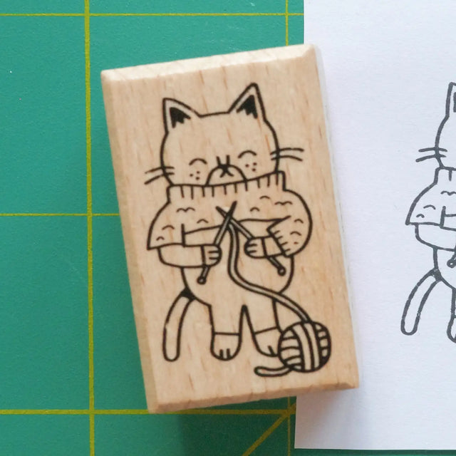 Decorate your planner or journal with this adorable stamp! Featuring a charming cat working on its knitting, this whimsical design is perfect for makers, knitters, crafters, and cat lovers alike.

1.5 x 1 inch wooden rubber stamp