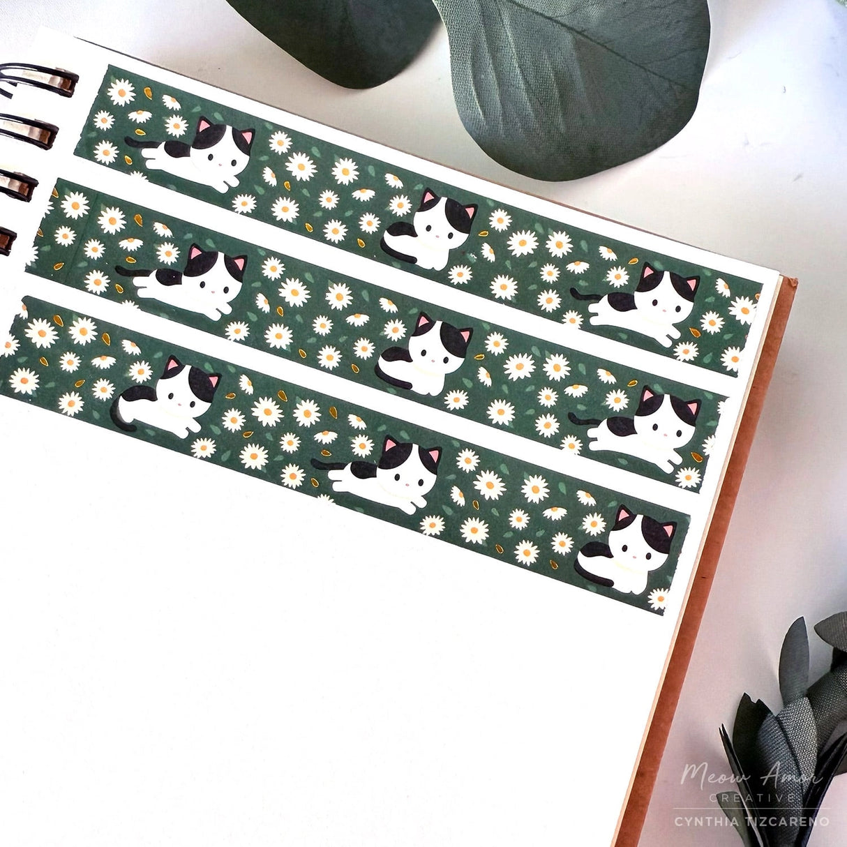 Decorate your projects with the Cow Cat Field Of Flowers Gold Foil Washi Tape. This sweet tape features playful cow-patterned cats surrounded by colorful flowers, highlighted with elegant gold foil details. Perfect for brightening up planners, gifts, and crafts with a gentle, cheerful touch.

Gold Foil Details&nbsp;
One 10-meter long roll of washi tape
15mm wide
32mm paper core