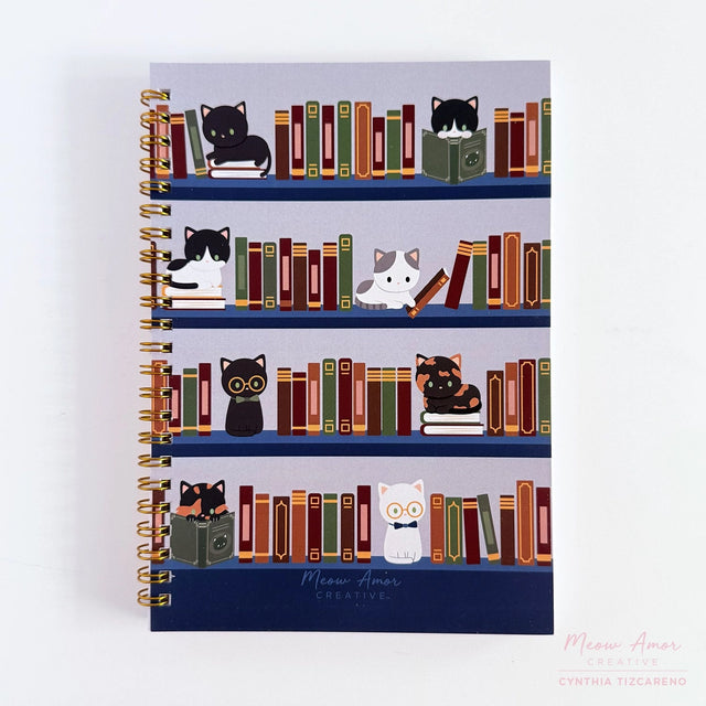 Jot down your notes in the book cats spiral notebook. Featuring book cat design, it's the perfect companion for journaling, sketching, and creative thoughts.