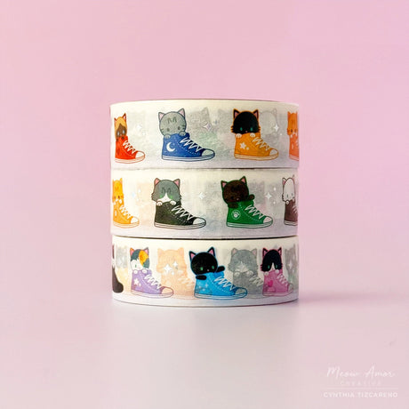 Vibrant washi tape with playful cats inside colorful sneakers, with small details of holographic foil. Ideal for journaling, scrapbooking, and craft projects.

Holo Foil Details
One 10-meter long roll of washi tape
5mm wide, 32mm
paper core&nbsp;