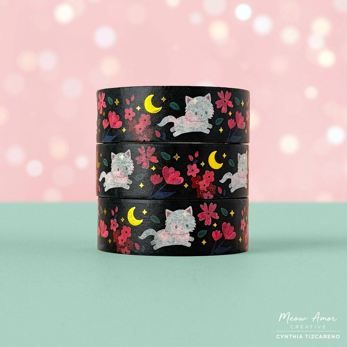Brighten your crafts with the Floral Fluffy White Cat Gold Foil Washi Tape. Featuring a fluffy white cat surrounded by delicate pink florals set against a sleek black background, this tape is enhanced with shimmering gold foil details for a charming and elegant look. Perfect for adding a sweet, stylish touch to your planners, gifts, and creative projects.

Gold Foil Details&nbsp;
One 10-meter long roll of washi tape
15mm wide
32mm paper core