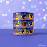 Add a magical glow to your projects with the Moon Cats Gold Foil Washi Tape. Featuring adorable cats surrounded by moon and star designs, this tape shines with elegant gold foil accents. Perfect for adding a cute, celestial touch to planners, gifts, and crafts.

Gold Foil Details&nbsp;
One 10-meter long roll of washi tape
15mm wide
32mm paper core