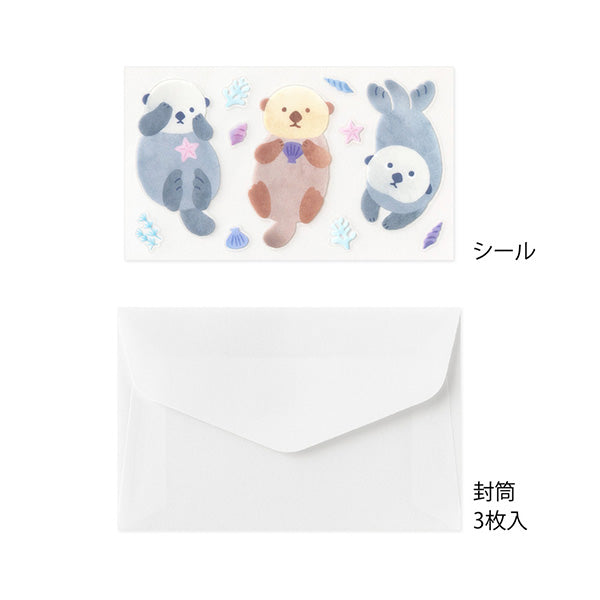 A refreshing stationery design based on blue, sprinkled with sea motifs such as coral, shells, and seaweed. On the writing side of the stationery, an otter's image is depicted floating comfortably on the sea. The adorable sea otter's sticker holding a shell or making a cute upward glance will make your cheeks soften