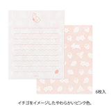 The set shows a rabbit stretching and chasing a strawberry. The stationery paper is a soft pink color inspired by strawberries. The ruled lines are designed to evoke the image of a rabbit bouncing around.