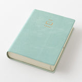 The Midori Diary Hibino 2027 is a fantastic tool for keeping track of your daily activities. This A6-sized notebook features a 2-page layout, making it easy to adapt to your unique needs. Starting in January 2027, each spread has identical left and right pages with a 2.5 mm grid, perfect for sketches and diagrams. The left page includes a 24-hour time axis, weather icons, and moon phases. It also comes with an annual calendar for an overview of the year, a 12-month future log to plan your goals month by mon