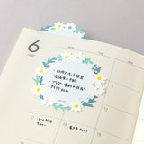 The "Wreath" design features delicate white florals in a wreath. It has a simple and easy-to-write design. If you peek out the die-cut part from a notebook or notebook, you can even use it like a bookmark.&nbsp;

The bottom of the sticker is glued, and when attached, the top floats slightly. The glue part is cut out as little as possible to prevent tearing when flipped.

Includes 20 notes in each package