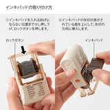 This fun rotating stamp by Midori allows you to choose from several designs and patterns that come with each stamp. The rotating stamp comes with an ink pad to be installed into the stamp before beginning to use it. This is a brown ink (soft color type) that blends well with the colors and decorations of writing instruments. Lock buttons on the side of the stamp allow you to lock the stamp into place when changing out the ink pad and when changing between designs to avoid mess.

These stamps are a great too