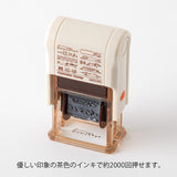 This fun rotating stamp by Midori allows you to choose from several designs and patterns that come with each stamp. The rotating stamp comes with an ink pad to be installed into the stamp before beginning to use it. This is a brown ink (soft color type) that blends well with the colors and decorations of writing instruments. Lock buttons on the side of the stamp allow you to lock the stamp into place when changing out the ink pad and when changing between designs to avoid mess.

These stamps are a great too