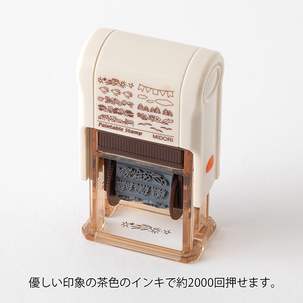 This fun rotating stamp by Midori allows you to choose from several designs and patterns that come with each stamp. The rotating stamp comes with an ink pad to be installed into the stamp before beginning to use it. This is a brown ink (soft color type) that blends well with the colors and decorations of writing instruments. Lock buttons on the side of the stamp allow you to lock the stamp into place when changing out the ink pad and when changing between designs to avoid mess.

These stamps are a great too