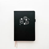 Soot Spirits Journal with Holographic Edges and Logo! ✨

Product Details:

Size: A5 (5.70 x 8.26 inches)
160 Dotted Grid Pages (5 x 5 mm)
2 Bookmarks
Elastic Band and Pen Holder
Expandable storage compartment