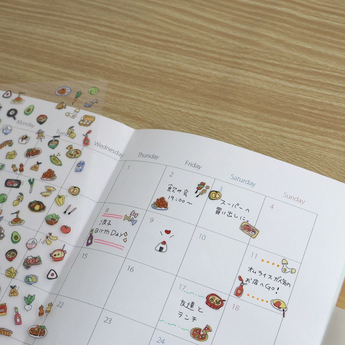 Calendar with illustrated food items on a wooden surface