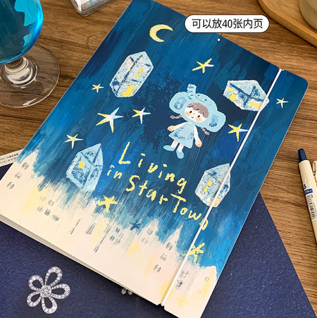 Molinta A5 Organizing Binder - Star Town

Designed in a six‑ring format, this binder is perfect for organizing ephemera, sticker sheets, journaling inserts, and creative plans. This&nbsp;A5 binder, gives you plenty of room to store larger pages, decorative layouts, and all the bits and pieces that make your journaling uniquely yours. Whether you're building sticker albums, creating themed spreads, or keeping your notes tidy, this binder offers a beautiful and functional way to keep everything in one place.
