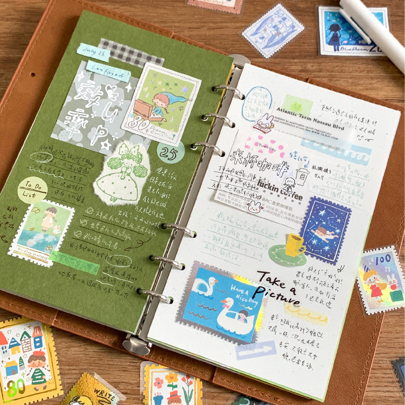 Molinta Postage Stamp Sticker Pack

Add a charming, vintage‑inspired touch to your journaling and crafting with these sticker packs. Designed to look like tiny collectible stamps, each one features delicate illustrations and foil accents that make every piece feel special. Whether you’re decorating planner spreads, pen‑pal letters, scrapbooks, or gift tags, these stickers bring a nostalgic, travel‑themed aesthetic to any project.

Red box - Gold foil
Blue box - Silver foil
Each box includes 30 total sticker