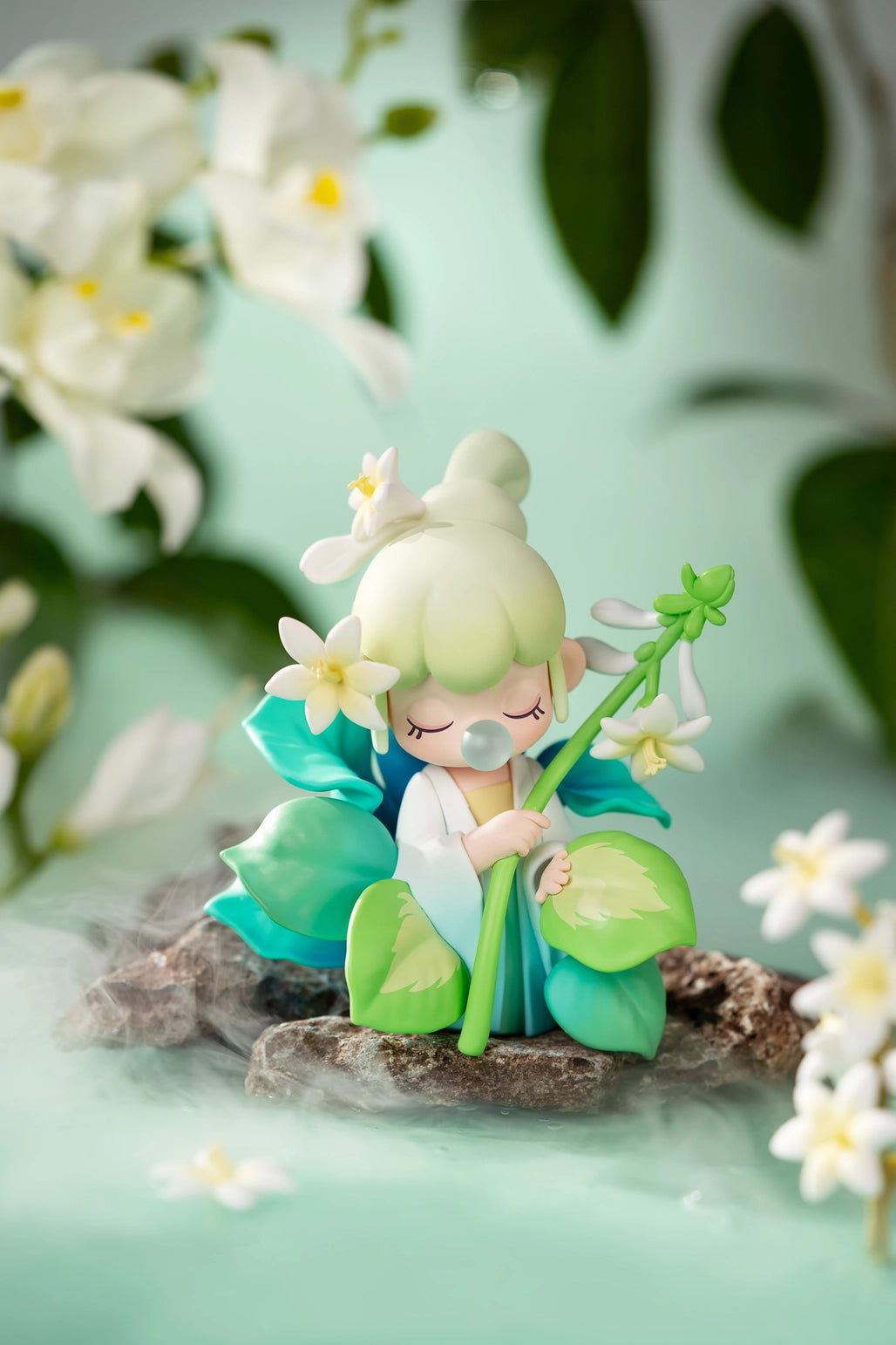 Nanci Flower Stories Figure Dolls Blind Box Small figurine of a fairy holding a flower with a soft focus background