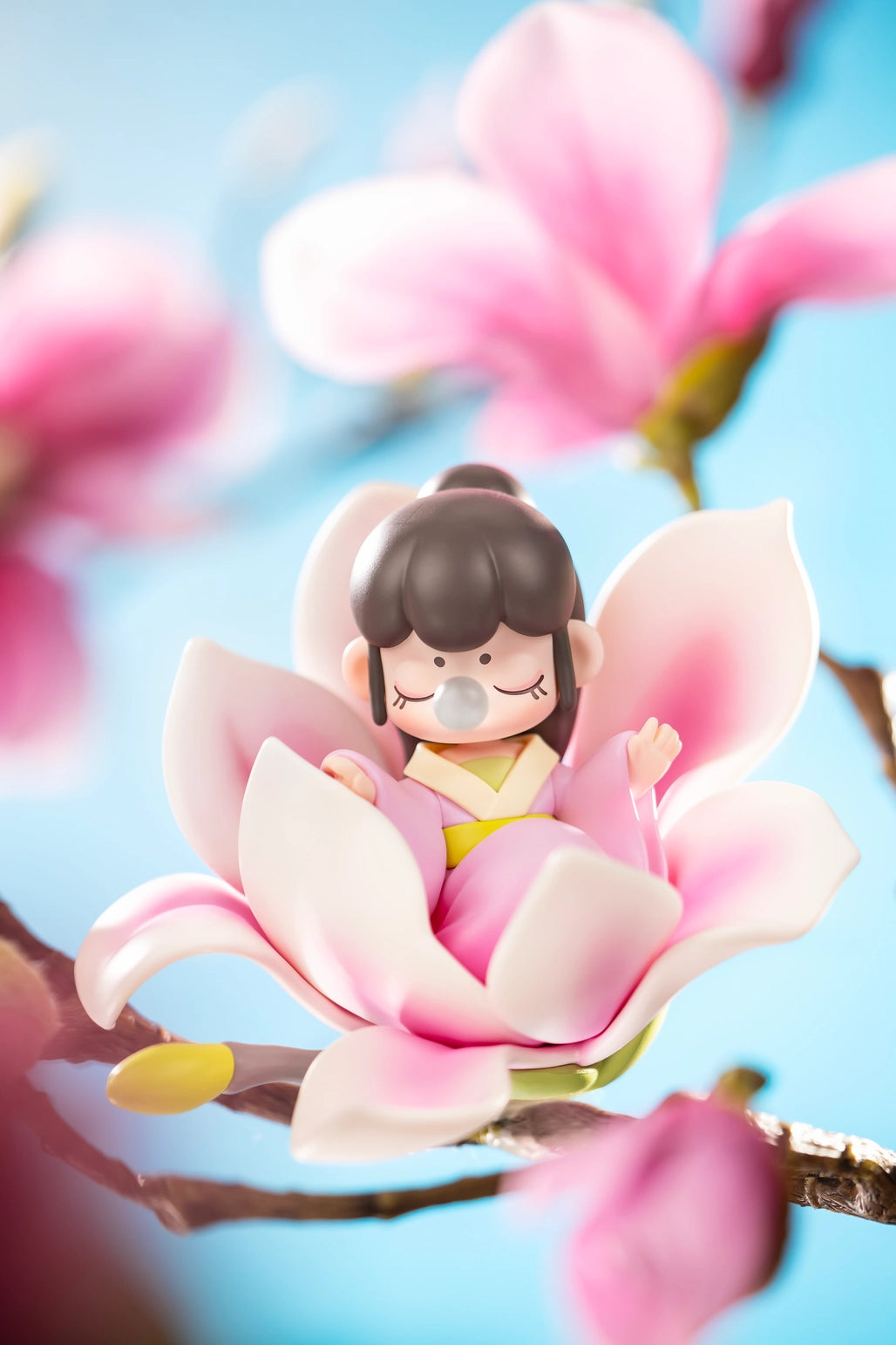 Nanci Flower Stories Figure Dolls Blind Box Figurine of a girl sitting on a pink flower with a blurred floral background