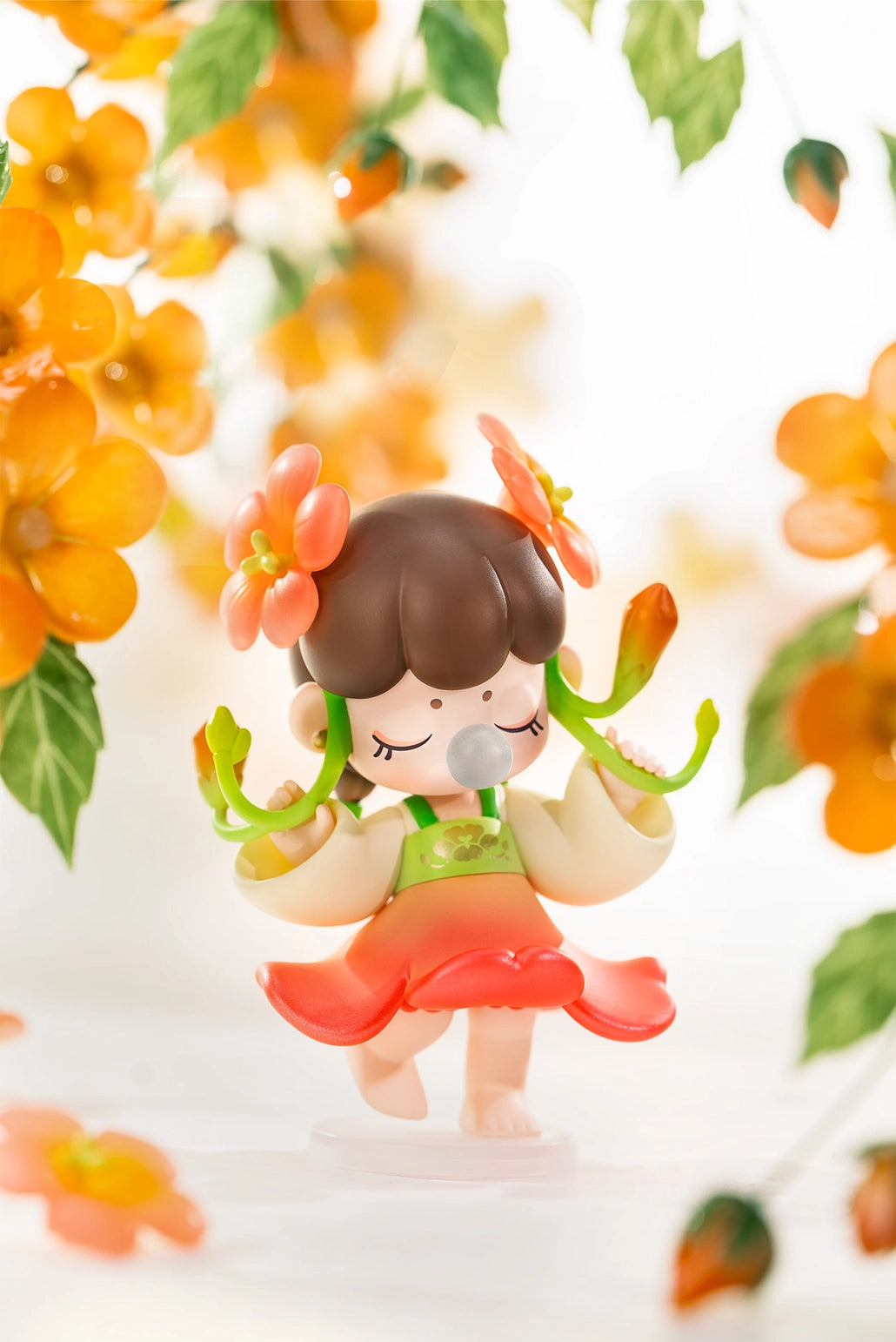 Nanci Flower Stories Figure Dolls Blind Box Figurine of a girl with flowers in her hair surrounded by orange flowers and green leaves on a white background