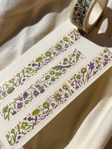 This washi tape features fluid green and purple flowers dancing loosely around to create an energetic, yet soft tape. 

This roll is 15mm wide x 10m of paper tape. Washi tape is super durable and flexible. It tears easily and can be safely applied to a variety of surfaces; it doesn’t leave a sticky residue behind, making it especially ideal for stationery and hanging prints temporarily.